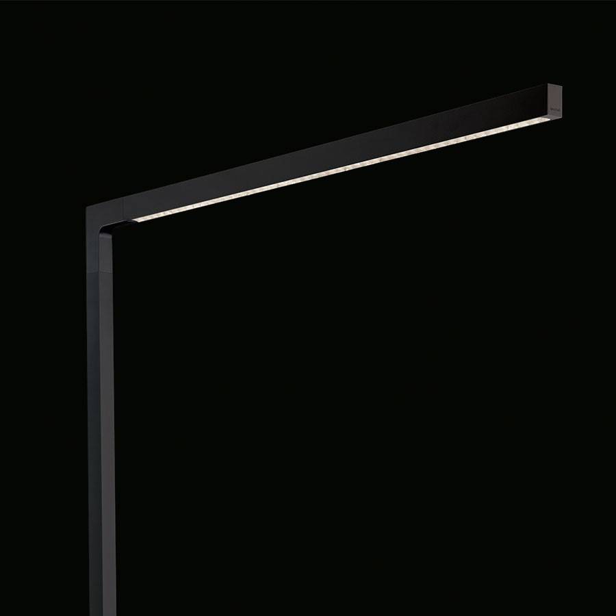 Czarno-szara, minimalistyczna lampa LED o prostokątnym kształcie, świecąca od góry do dołu; na czarnym tle.