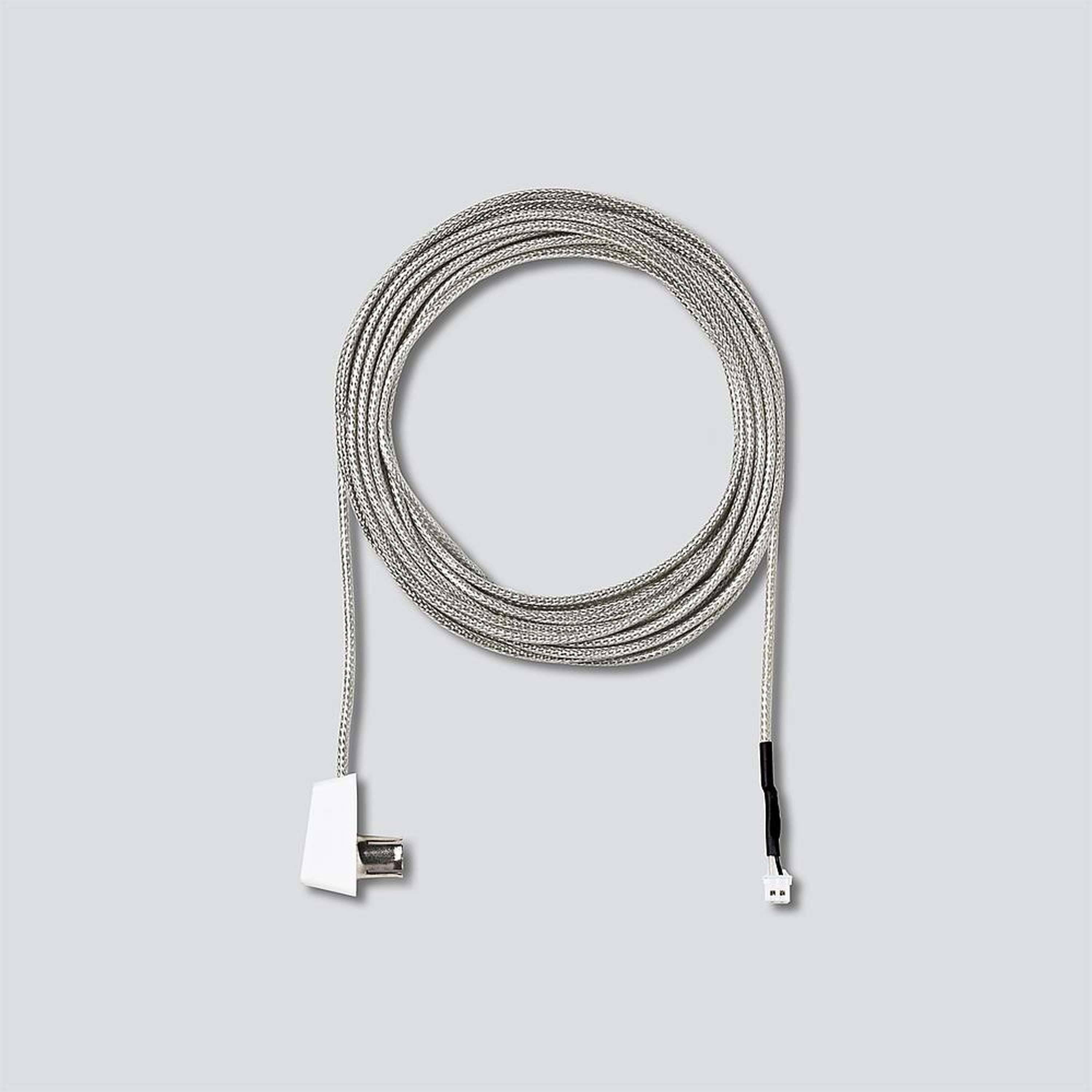 Pleciony kabel USB w srebrnym i białym kolorze, spiralnie zwinięty na szarym tle.