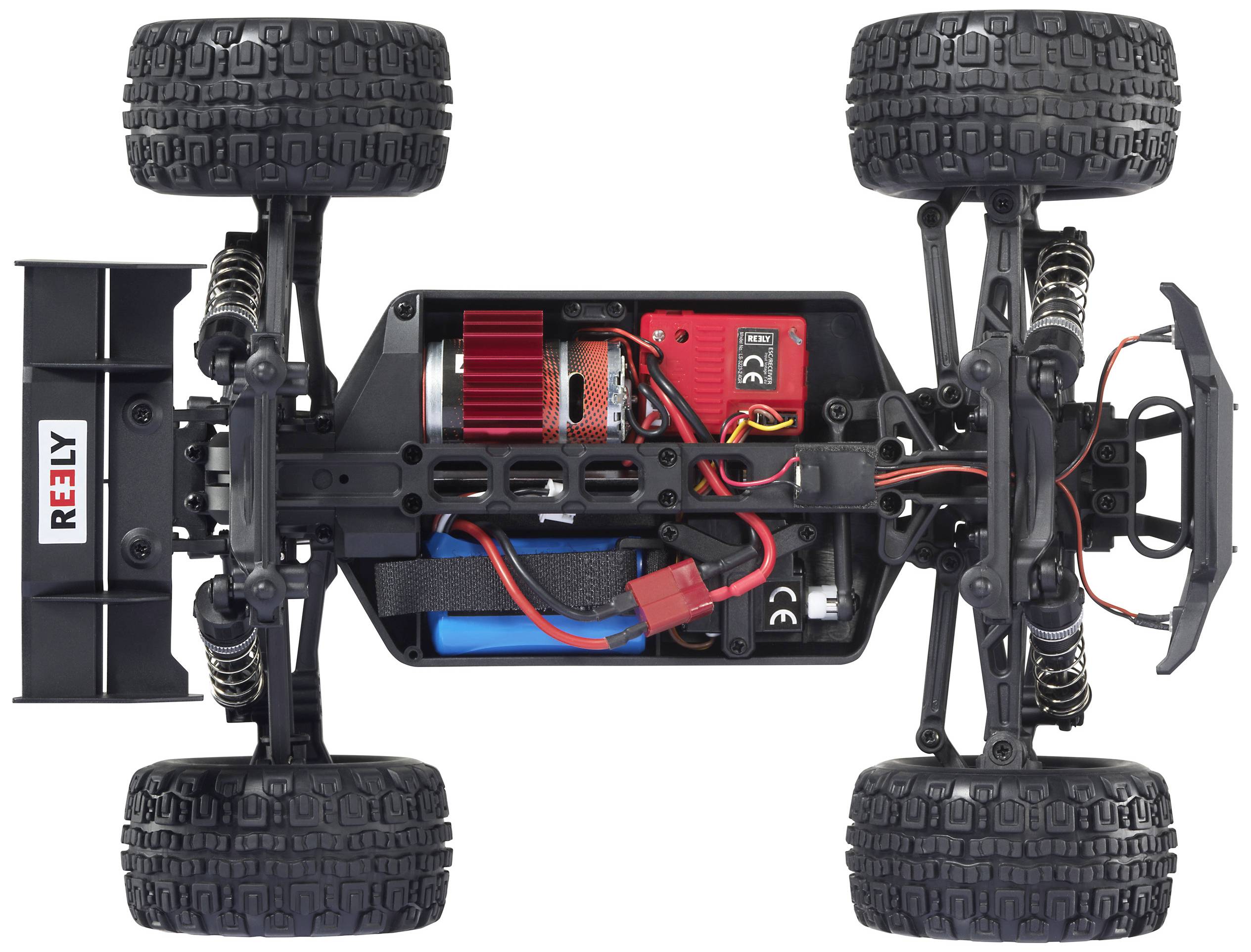 Zdalnie sterowany samochód widziany z góry, ukazujący wewnętrzny układ z widocznymi komponentami, takimi jak silnik, akumulator i okablowanie.