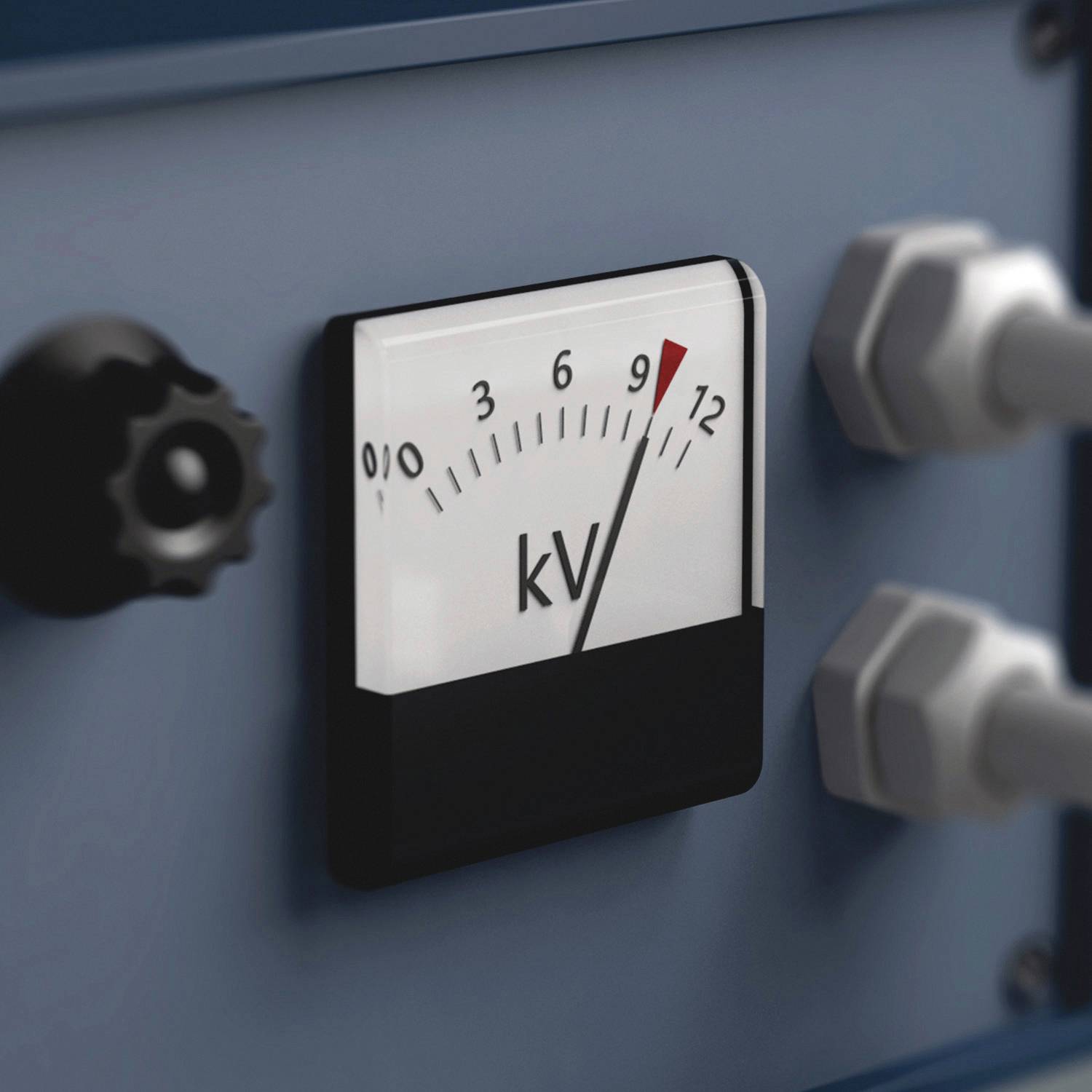 Analogowy miernik wskazuje 9 kV w zakresie od 0 do 12 kV. Widoczna część urządzenia z pokrętłem i dwoma złączami.