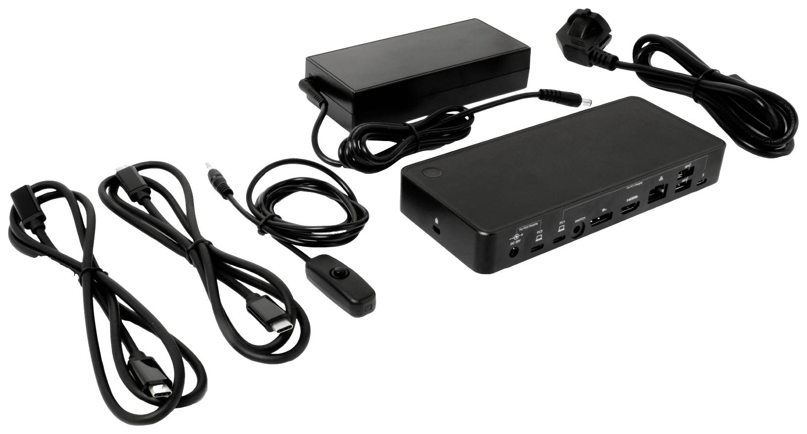 Złącza i kable do stacji dokującej są ułożone na stole, w tym kabel HDMI i zasilacz.