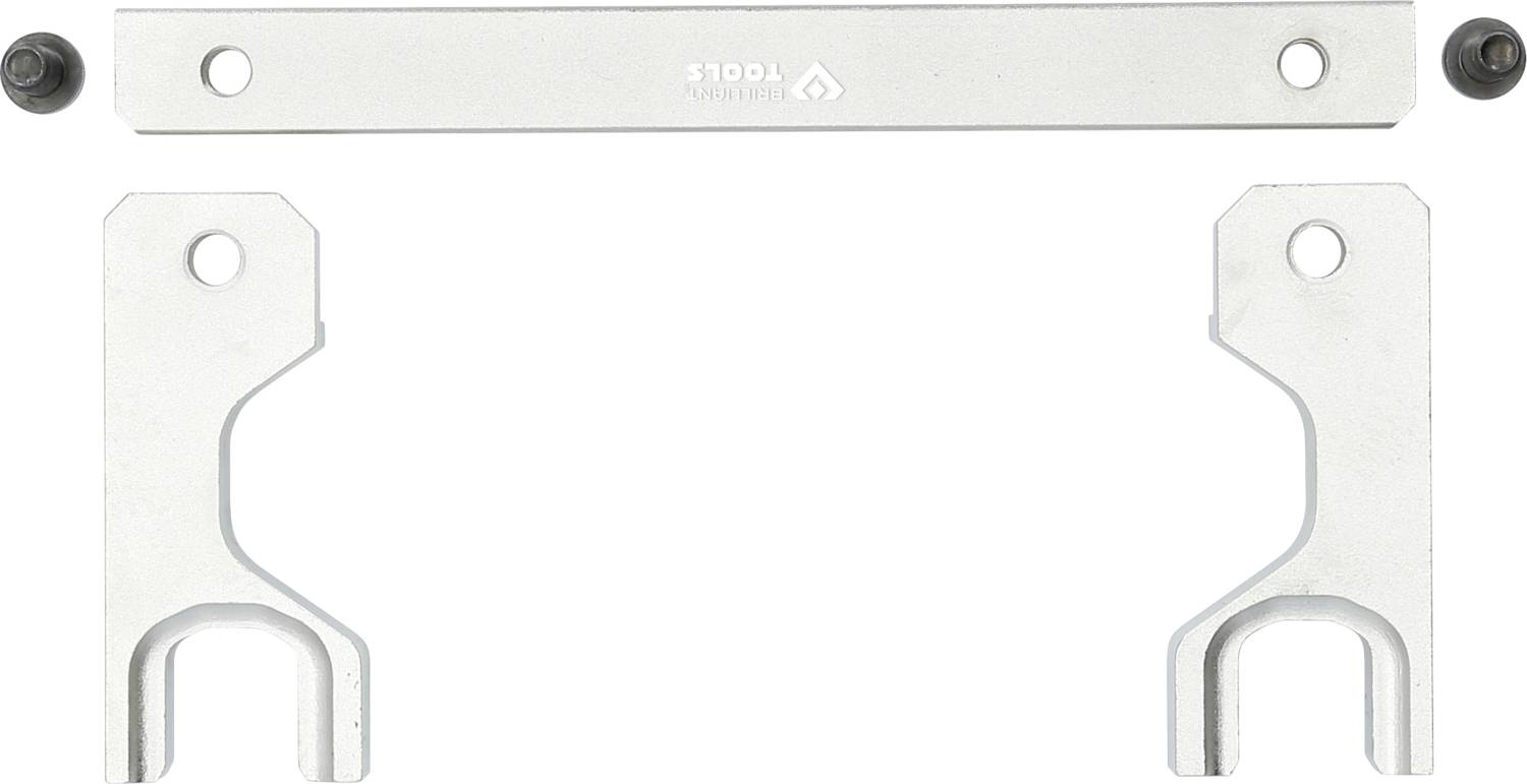 Dwie srebrne obejmy ze śrubami, prawdopodobnie część zestawu montażowego lub mocującego, ułożone symetrycznie.