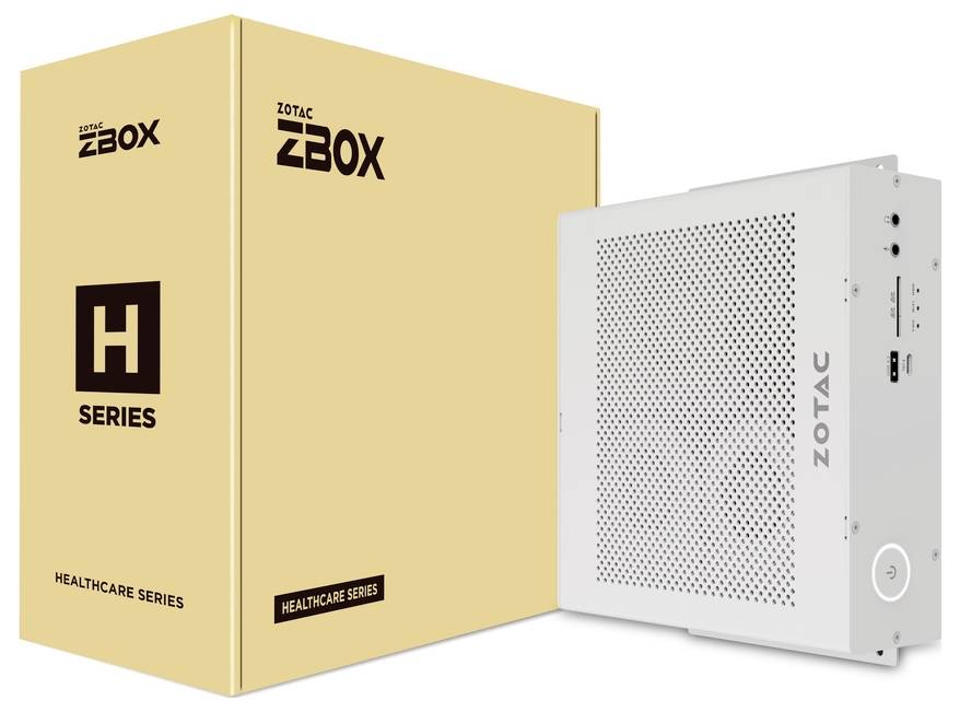 Biały minikomputera ZOTAC z serii Healthcare stoi przed żółtawym opakowaniem oznaczonym napisem 'H Series'.