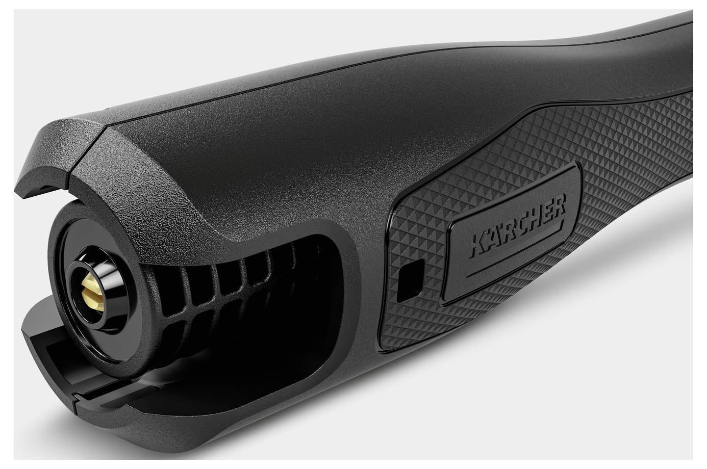 Zbliżenie rękojeści czarnej myjki ciśnieniowej Kärcher, prezentujące teksturowany uchwyt i port przyłączeniowy.