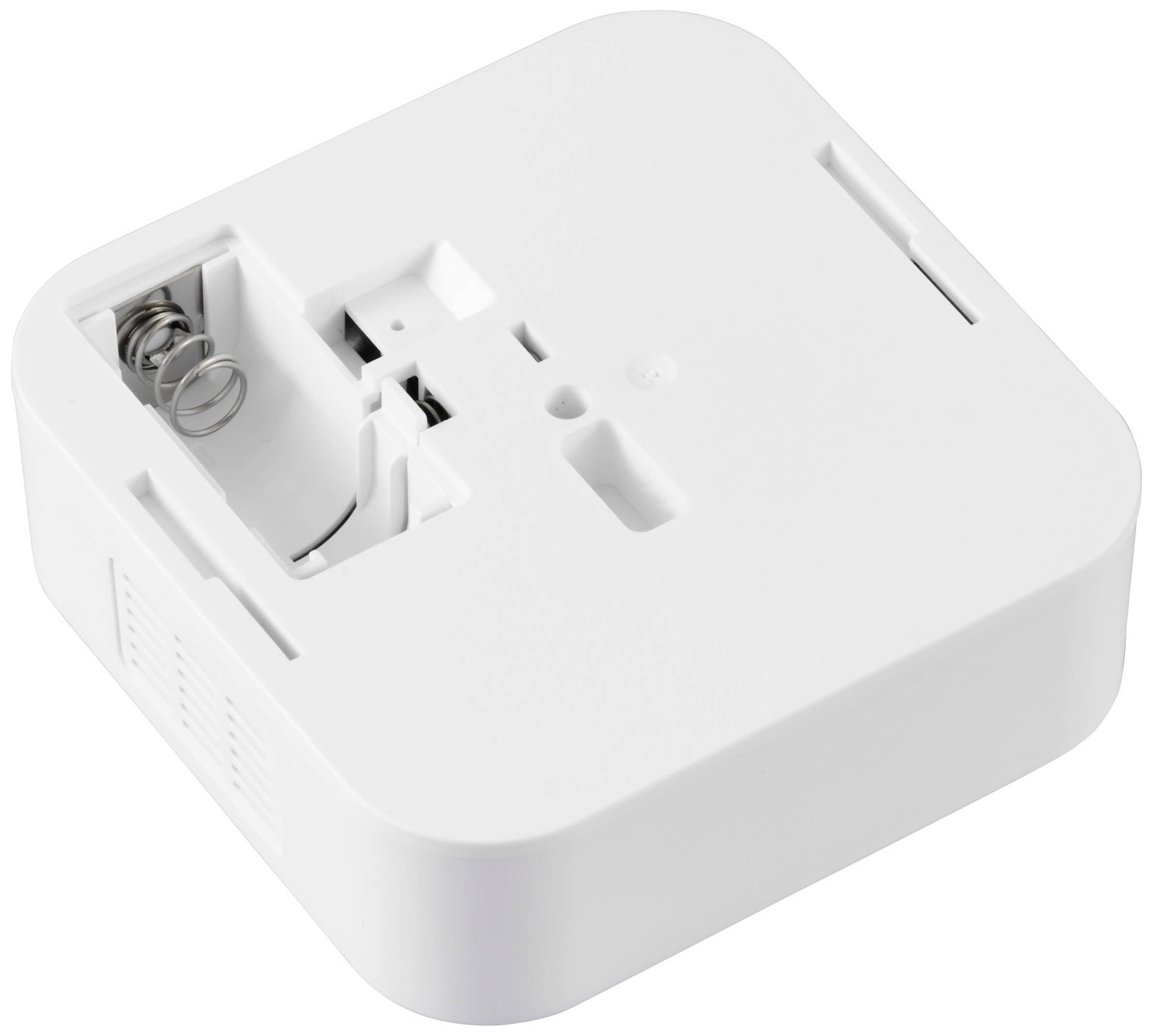 Białe urządzenie elektroniczne z komorą na baterie, otwarte, bez baterii. Kwadratowy kształt, minimalistyczny design.