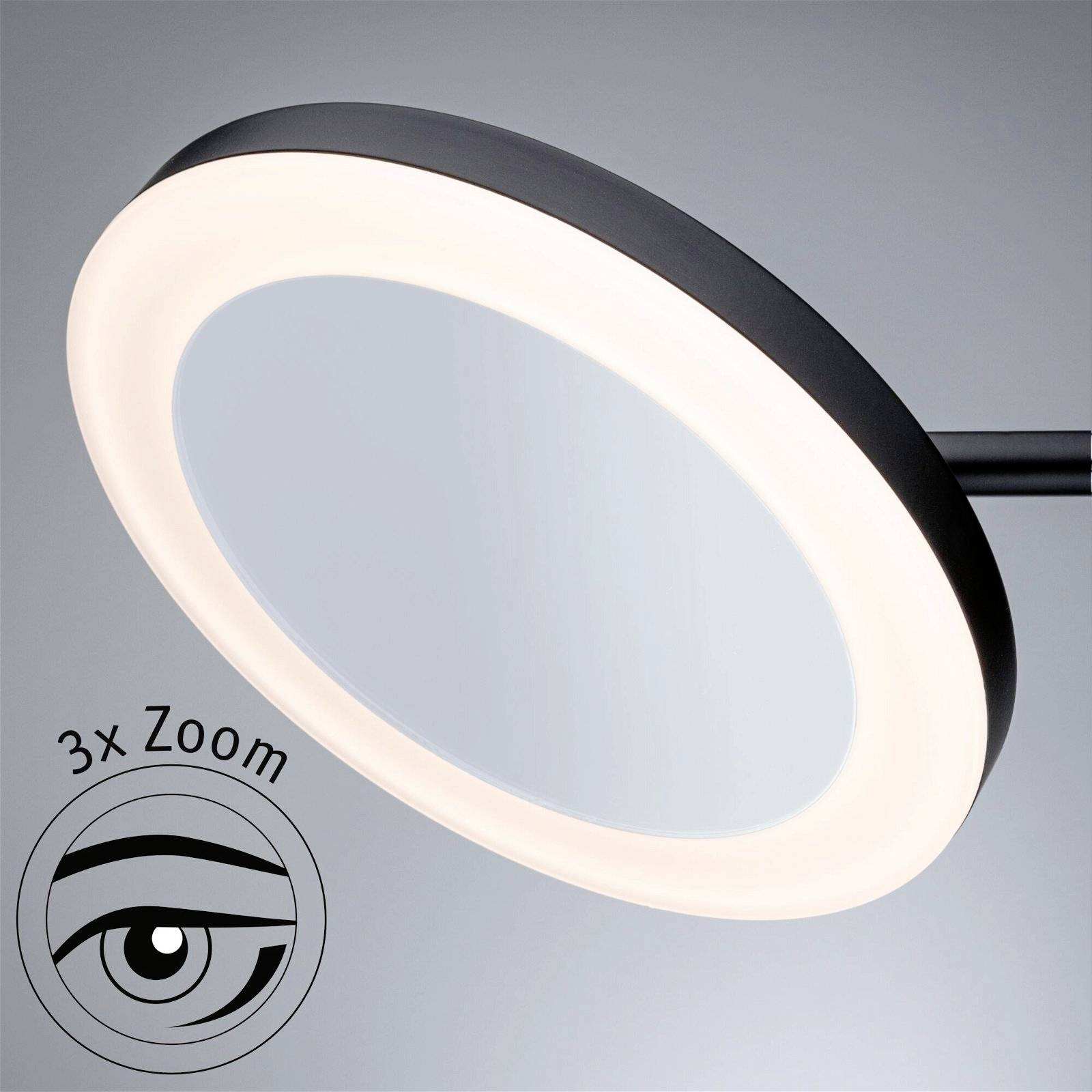 Lusterko powiększające z podświetleniem LED, czarna obwódka. Tekst '3x Zoom' i symbol oka, wskazujący funkcję powiększenia.
