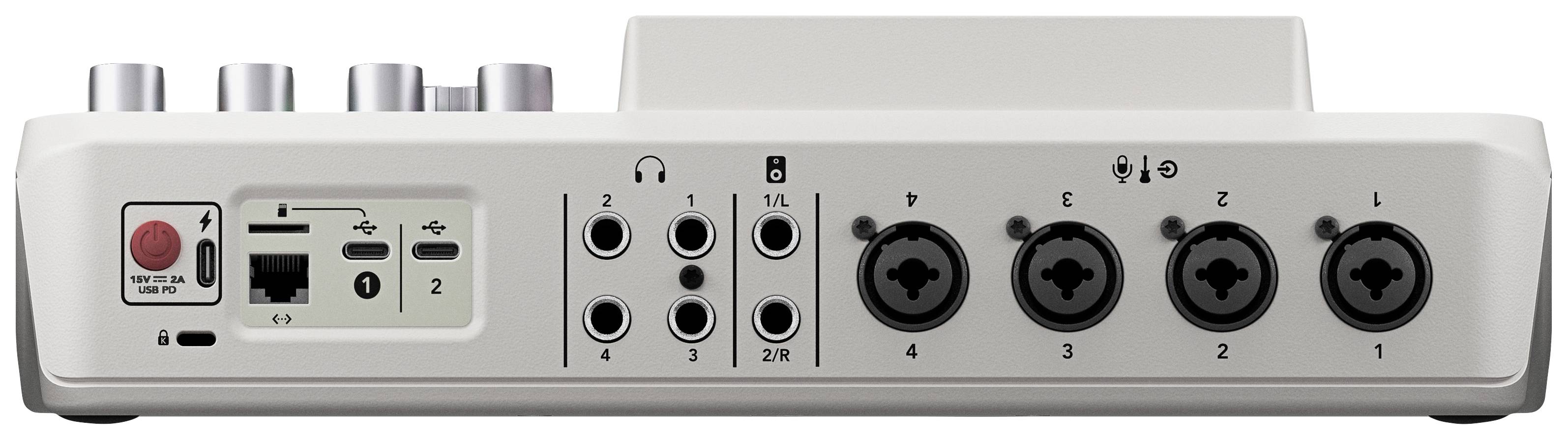 Interfejs audio z wieloma wejściami i wyjściami, w tym złączami XLR, gniazdami słuchawkowymi i regulatorami, na białej powierzchni.