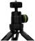Czarny statyw z regulowaną głowicą i zieloną poziomicą, odpowiedni dla aparatów fotograficznych i innych urządzeń.