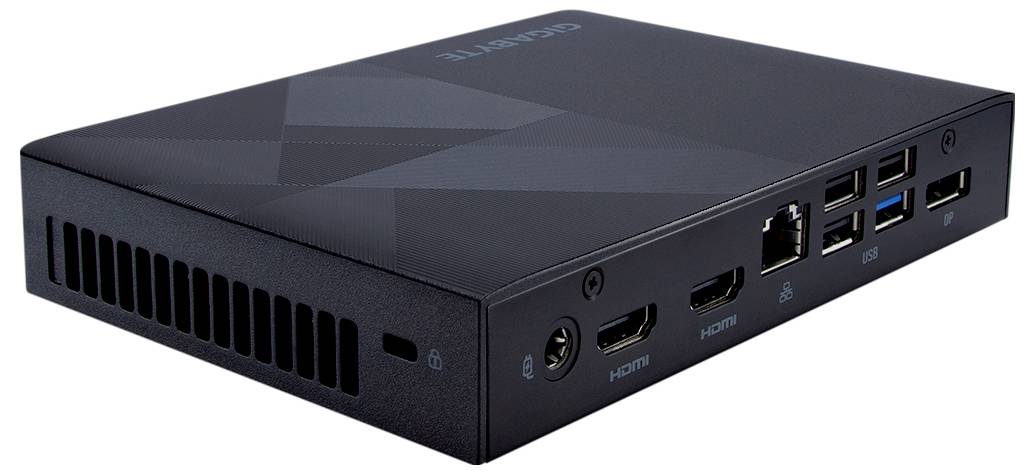 Kompaktowy komputer z wieloma portami: HDMI, USB, Ethernet i Audio. Obudowa w kolorze czarnym z dyskretnym wzorem.