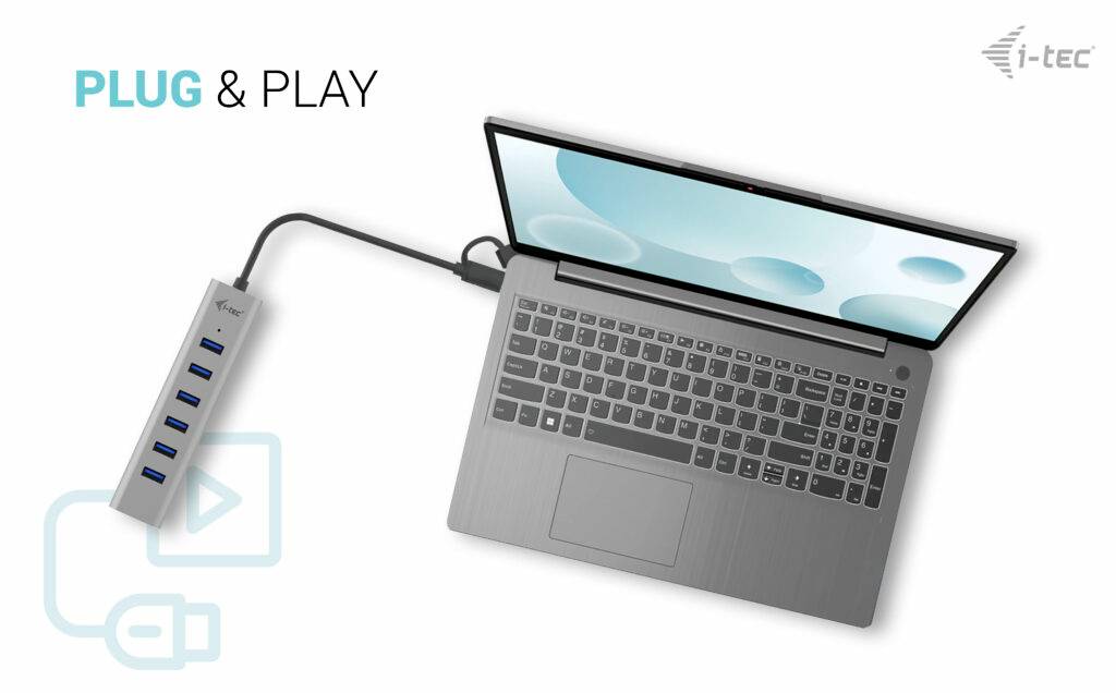 Laptop z podłączonym hubem USB oferującym pięć portów USB. W lewym górnym rogu napis "PLUG & PLAY".