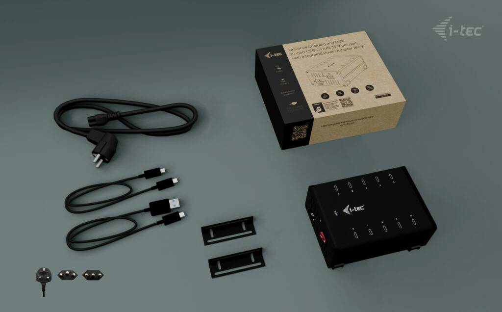 Na ilustracji przedstawiono zestaw składający się z czarnej obudowy urządzenia, dwóch uchwytów, kabla z wtyczką, kabla USB oraz opakowania.