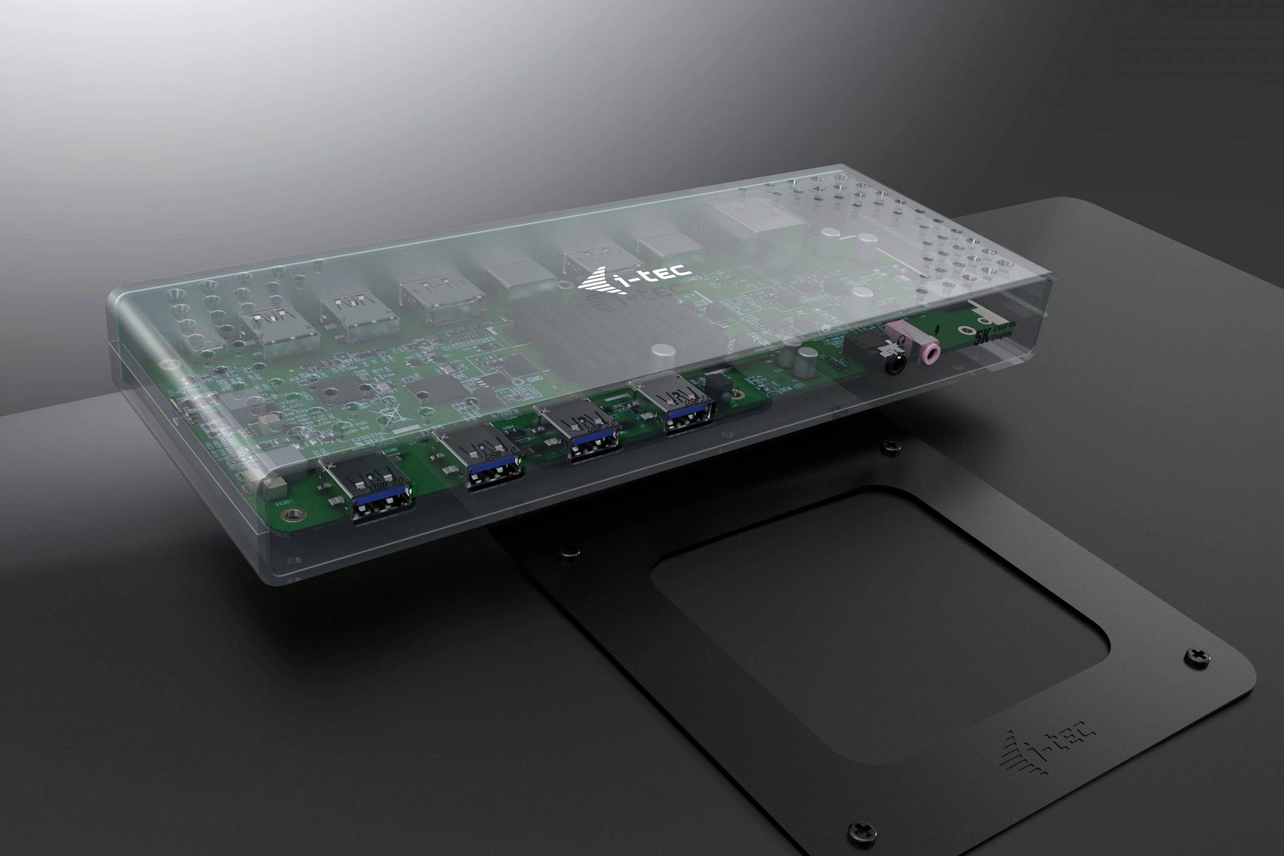 Przezroczyty układ elektroniczny z wieloma złączami i logo, umieszczony na ciemnym podłożu.