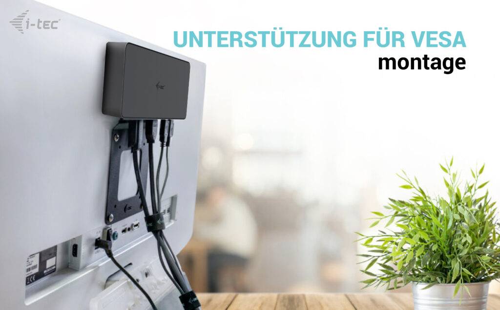 'Monitor z tyłem skierowanym w stronę kamery, zamontowany na uchwycie VESA. Podłączonych jest kilka kabli. Tekst: Wsparcie dla montażu VESA.'