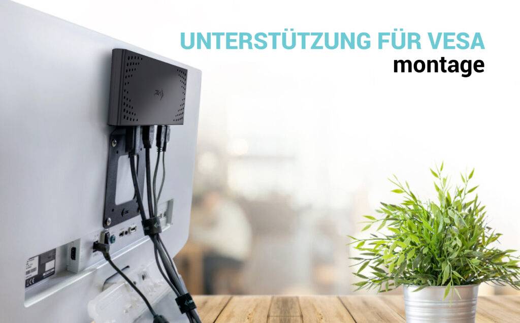 Wsparcie dla montażu VESA przedstawia ekran komputera z zamontowanym mini-PC na tylnej ściance, z rośliną na pierwszym planie.