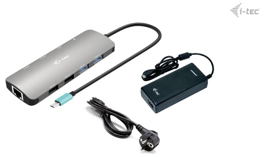 Srebrna stacja dokująca z wieloma portami USB, portem Ethernet oraz złączem ładowania, obok której znajduje się zasilacz z przewodem zasilającym.