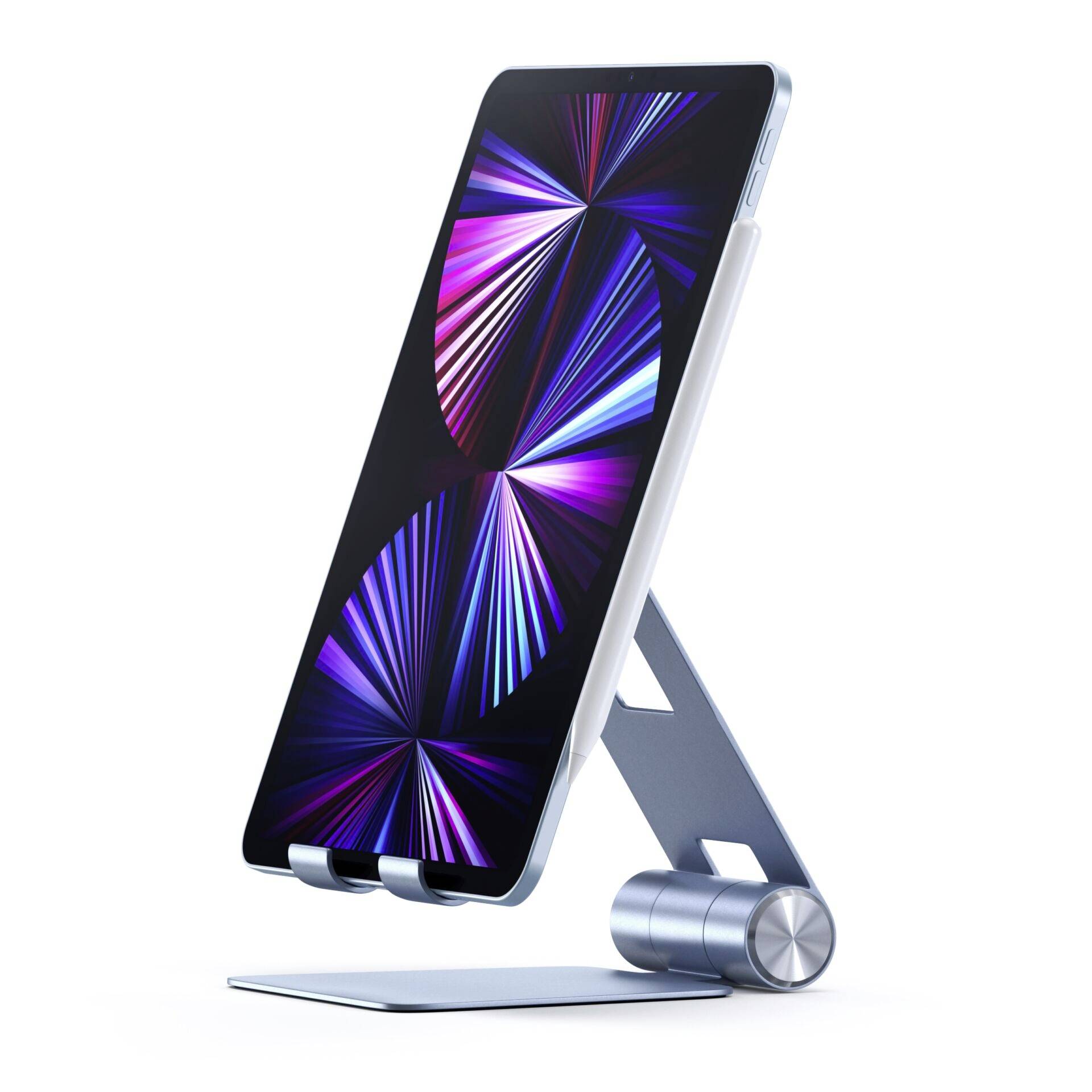 Tablet z podświetlonym ekranem stoi na nowoczesnym, srebrnym stojaku. Na ekranie widać kolorowe, abstrakcyjne kształty.