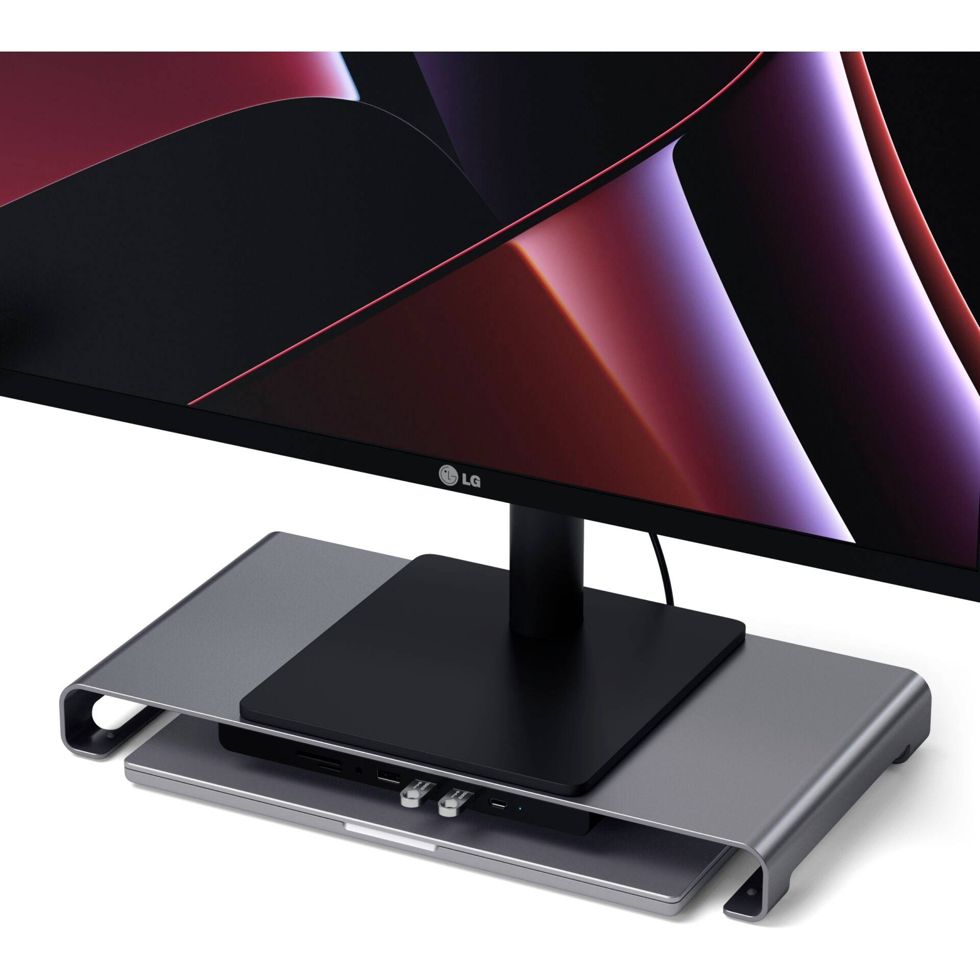 Nowoczesny monitor LG stoi na smukłej srebrnej podstawie, która służy jako powierzchnia do organizacji kabli.