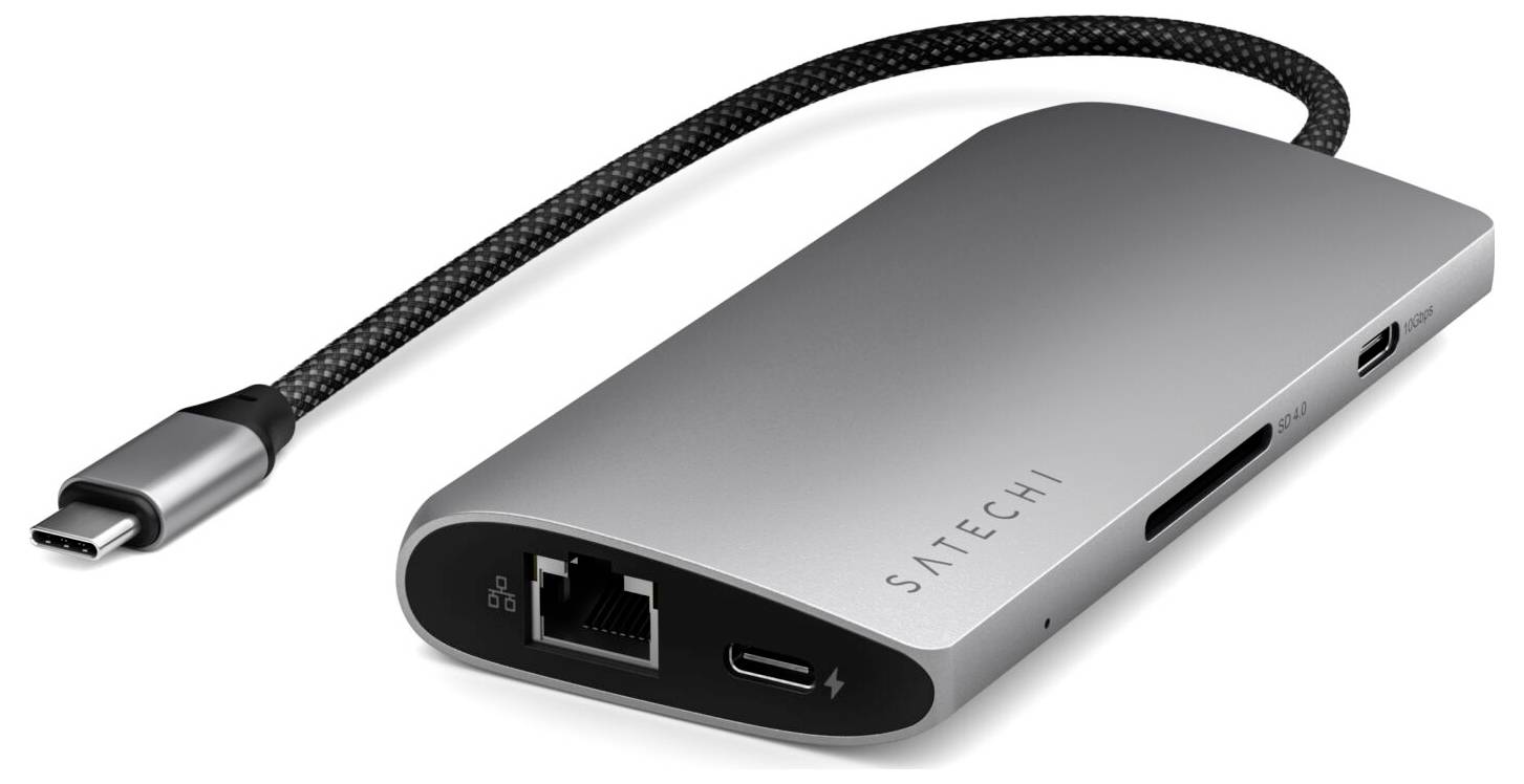 Srebrny hub USB-C z wieloma portami, w tym HDMI, USB-A, Ethernet oraz gniazda kart SD. Łączy urządzenia z laptopem.