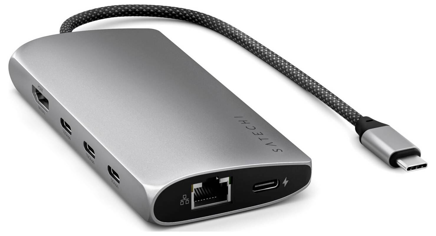 Srebrny hub USB-C z wieloma portami, w tym HDMI, USB-A, Ethernet i USB-C, oferuje wszechstronne możliwości podłączenia urządzeń.