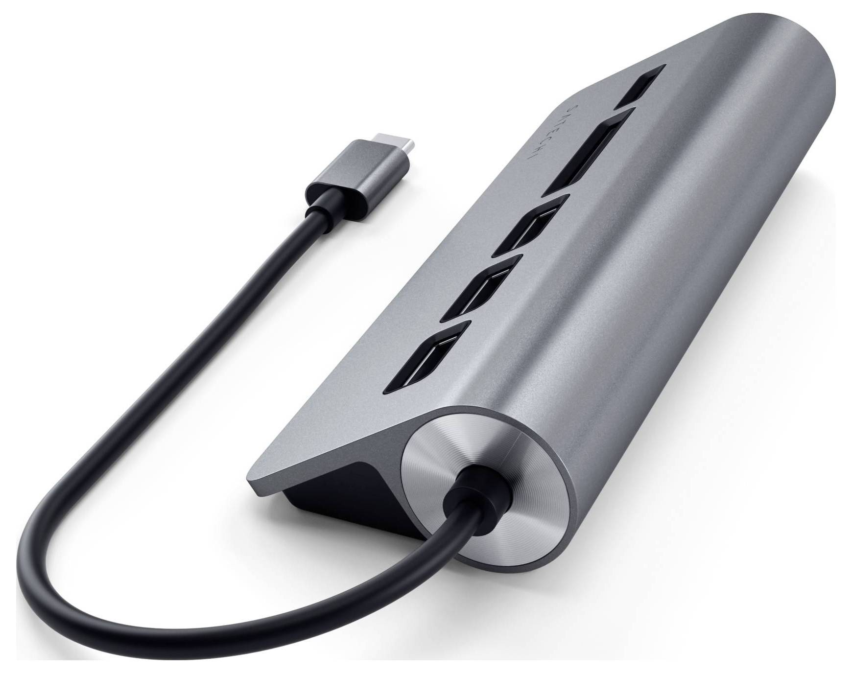 Zewnętrzny hub USB-C w metalowej obudowie w kolorze antracytowym z wieloma złączami, w tym USB i HDMI. Służy do podłączania urządzeń do laptopów.