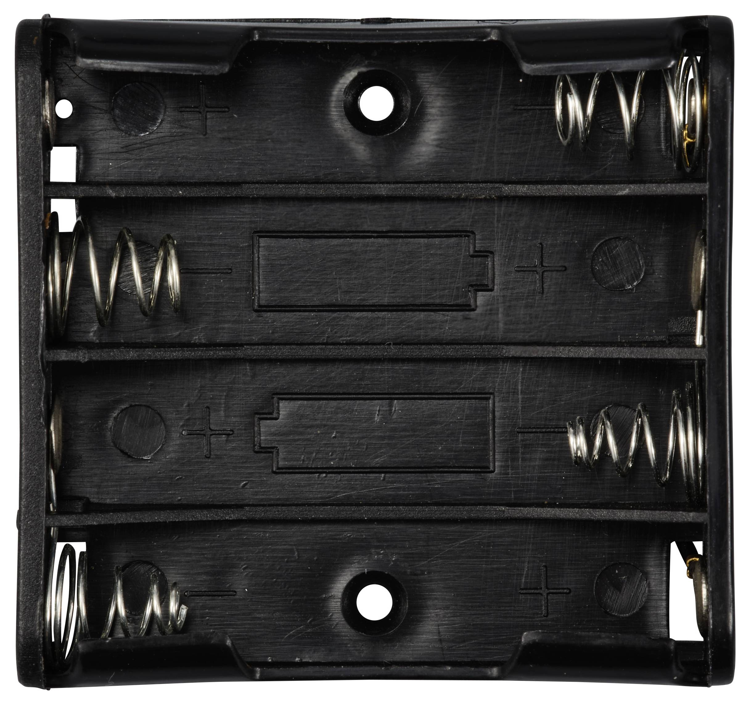 Uchwyt na baterie z czarnego tworzywa sztucznego na cztery baterie AA, widok z góry z sprężynkami oraz oznaczeniami biegunów plus i minus.