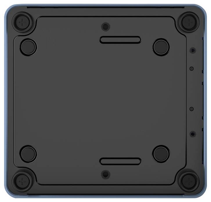 Spód czarnego urządzenia elektronicznego z czterema gumowymi stopkami w narożnikach, prawdopodobnie komputera lub urządzenia peryferyjnego.