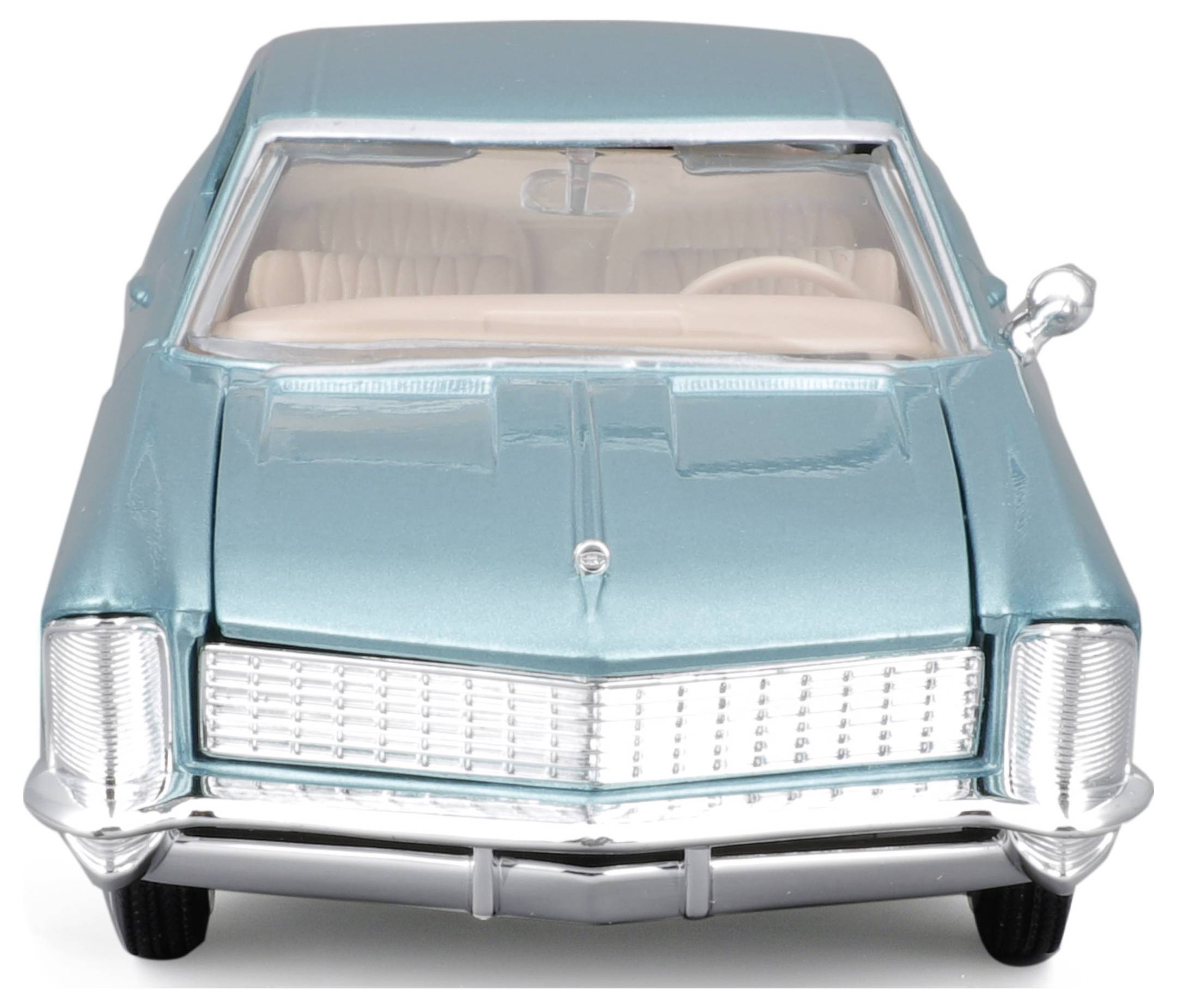 Turkusowy model samochodu w stylu retro, widziany z przodu, z widocznym grillem chłodnicy i reflektorami.