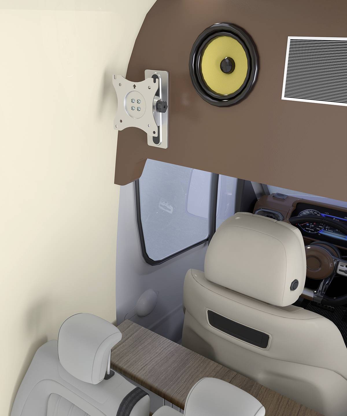 Wnętrze kampera z widokiem na kokpit. Widoczne są beżowe siedzenia, głośnik zamocowany na ścianie oraz uchwyt na ekran.