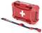 Czerwony zestaw pierwszej pomocy z białym symbolem krzyża na przedniej stronie leży obok czarnego paska do przenoszenia z napisem 'Nanuk NANO'.