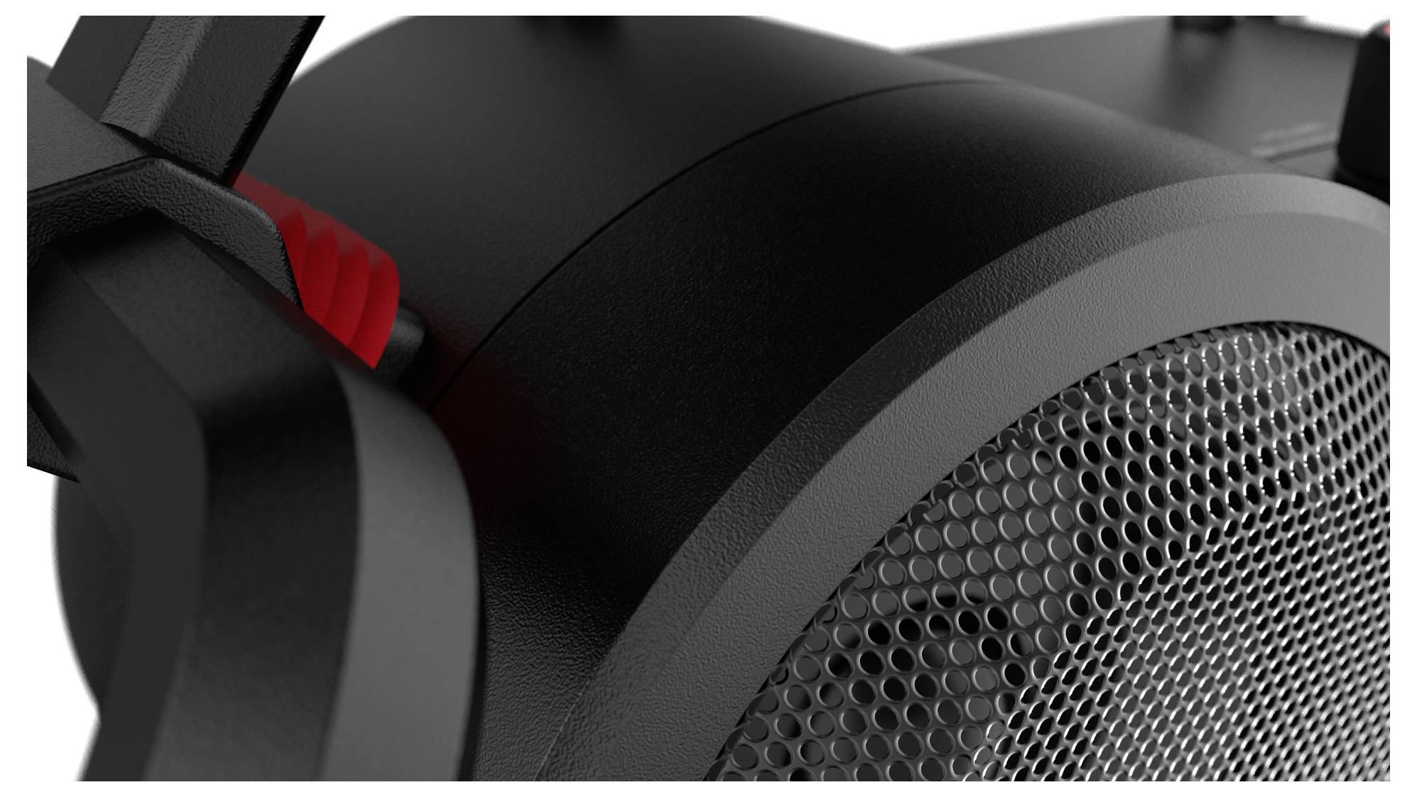 Zbliżenie czarnego głośnika z czerwonym złączem kablowym. Kratka głośnika jest wyraźnie widoczna.