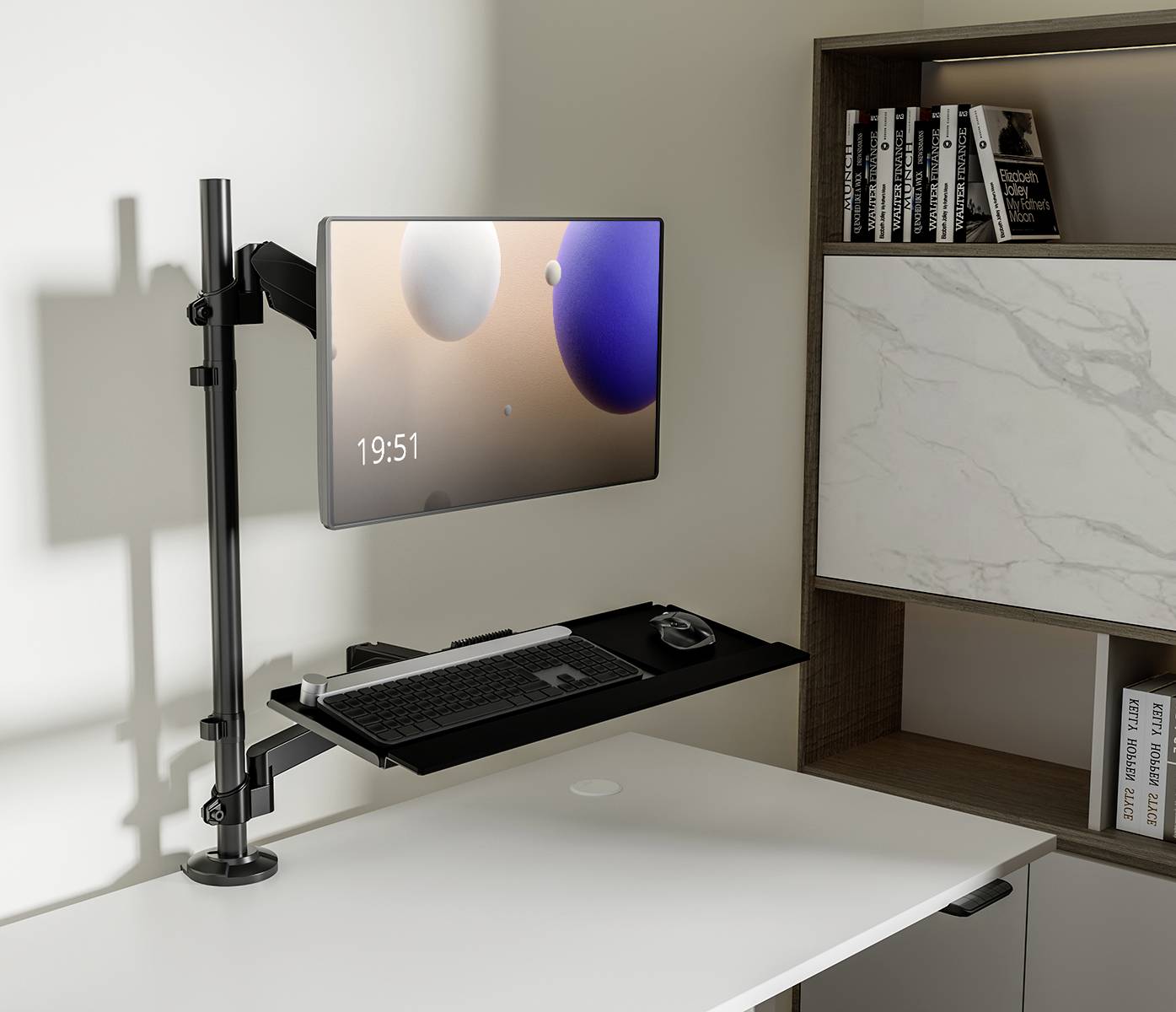 Minimalistyczne biurko z zamontowanym ekranem, klawiaturą i myszą. Na tle regału z książkami, godzina 19:51.