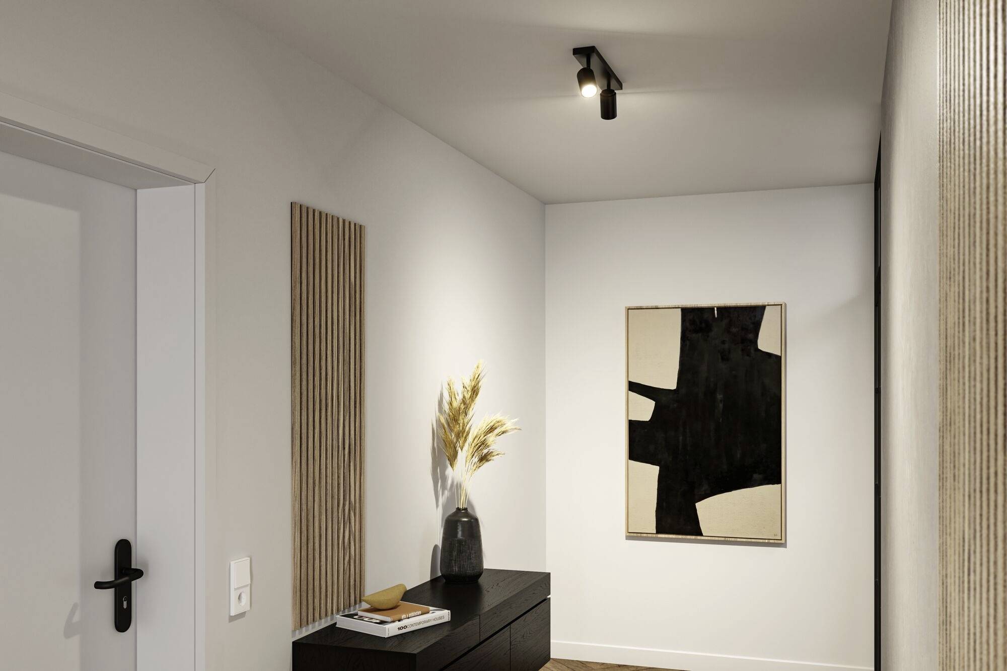 Nowoczesny biały korytarz z czarną komodą, ozdobiony wazonami i suszonymi kwiatami; abstrakcyjny obraz na ścianie.