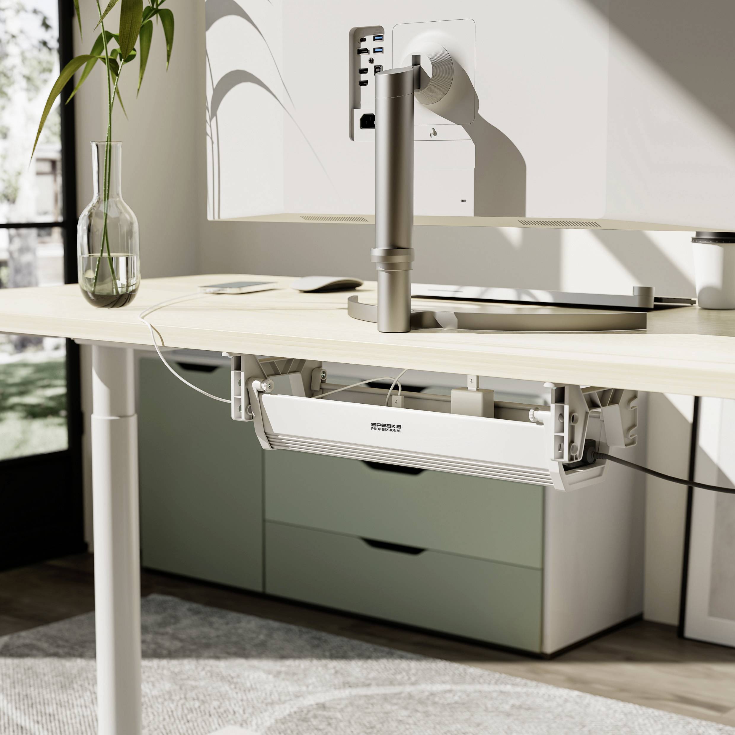 Nowoczesne biurko z regulowanym ramieniem monitora, wazonem na rośliny i naturalnym światłem wpadającym przez okno. Minimalistyczny design.