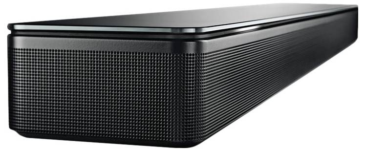 Czarna soundbar o gładkiej sylwetce i zaokrąglonych krawędziach, stojąca na szklanej górnej powierzchni.