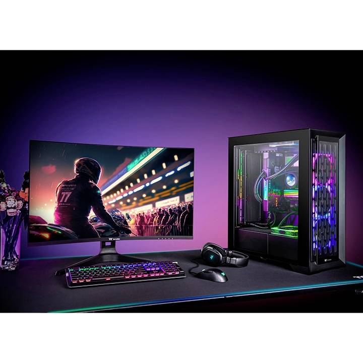 Biurko z podświetlanym zestawem do gier: monitor wyświetla grę wyścigową; obok podświetlony komputer dla graczy, klawiatura i mysz.