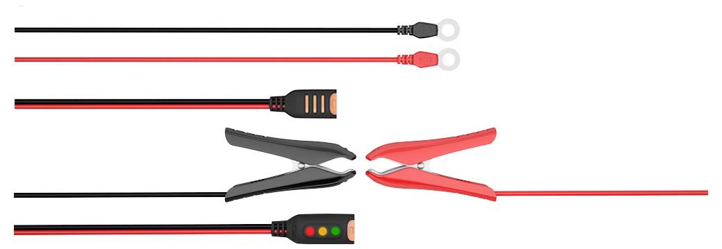 Czerwone i czarne zaciski krokodylkowe z przewodami i końcówkami oczkowych. Zaciski są zamknięte; dwie wskazówki na uchwytach.