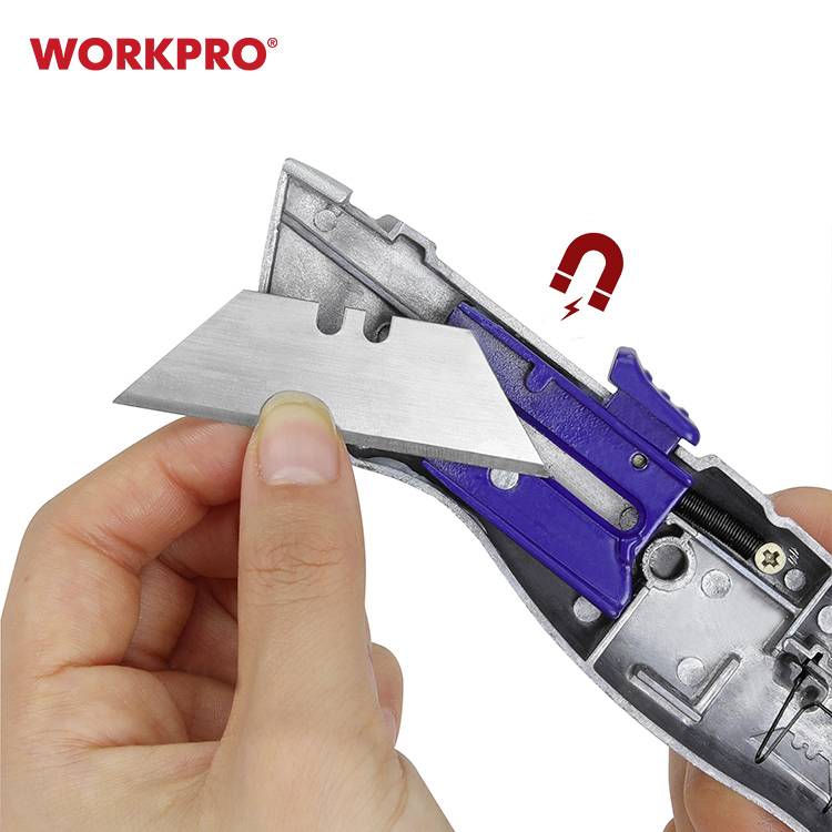 Osoba trzyma nóż monterski, otwiera go, aby wymienić ostrze. Magnes przyciąga ostrze. Widoczna marka 'WORKPRO'.