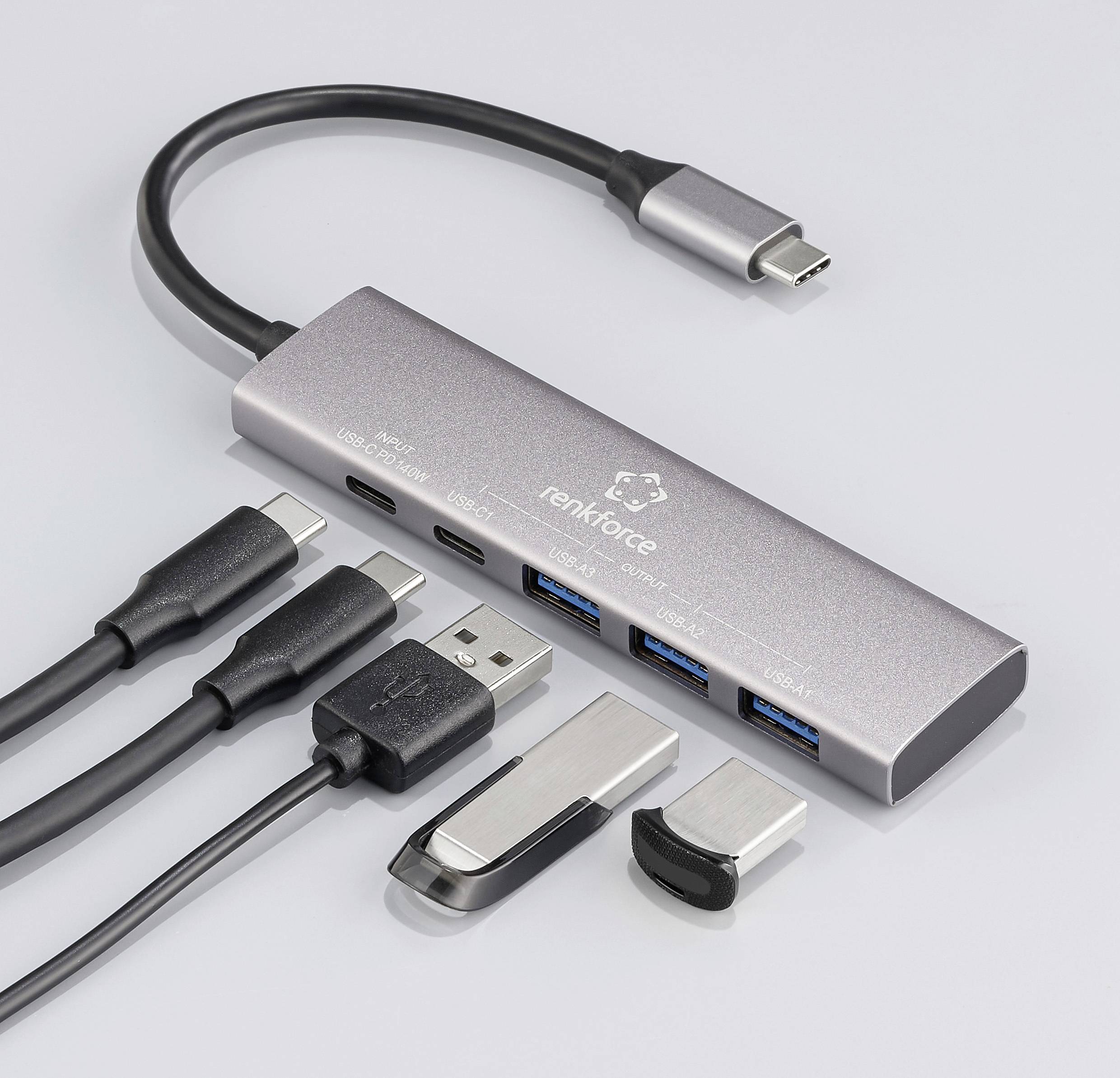 Koncentrator USB-C z wieloma portami: dwa porty USB-A, dwa porty USB-C oraz HDMI. Podłączone kable leżą obok. Idealny do laptopów.