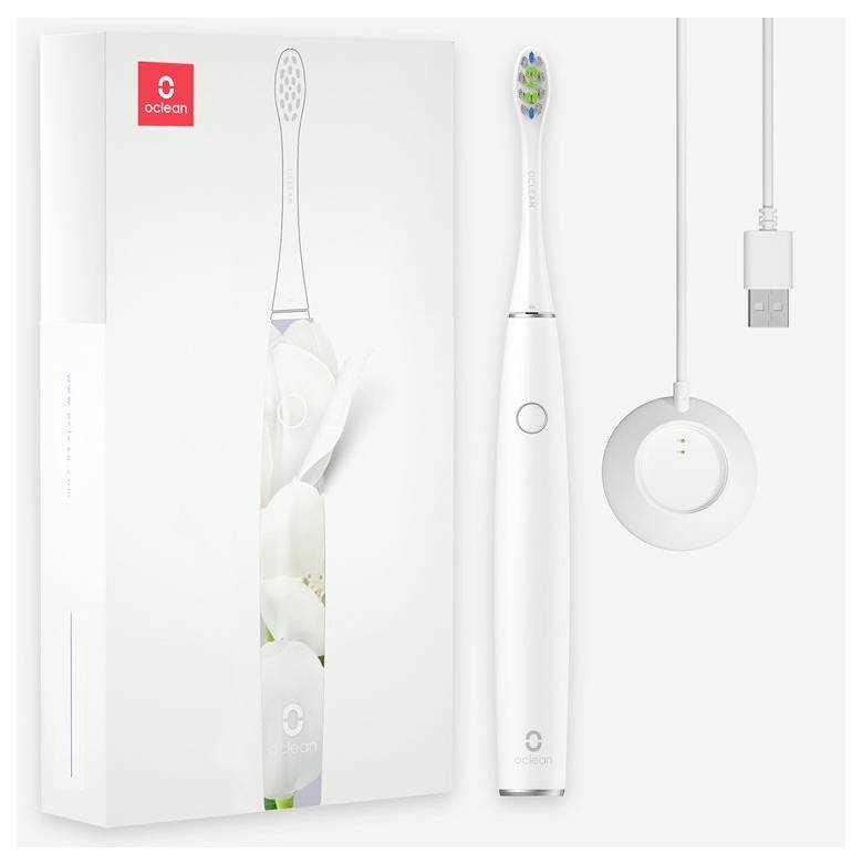 Elektryczna szczoteczka do zębów z ładowarką i opakowaniem. Opakowanie prezentuje elegancki design z białymi motywami kwiatowymi.