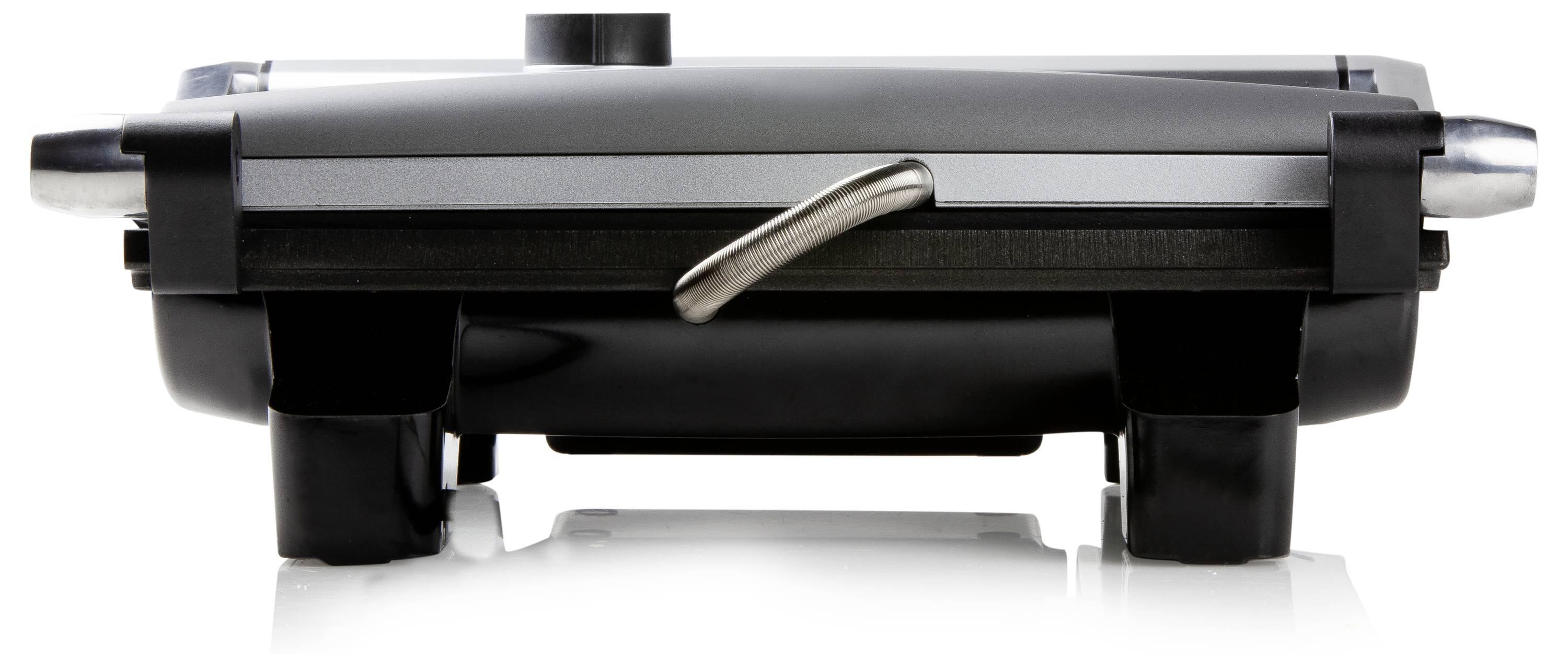 Opiekacz do kanapek ze stali nierdzewnej, sfotografowany z boku na błyszczącej powierzchni.