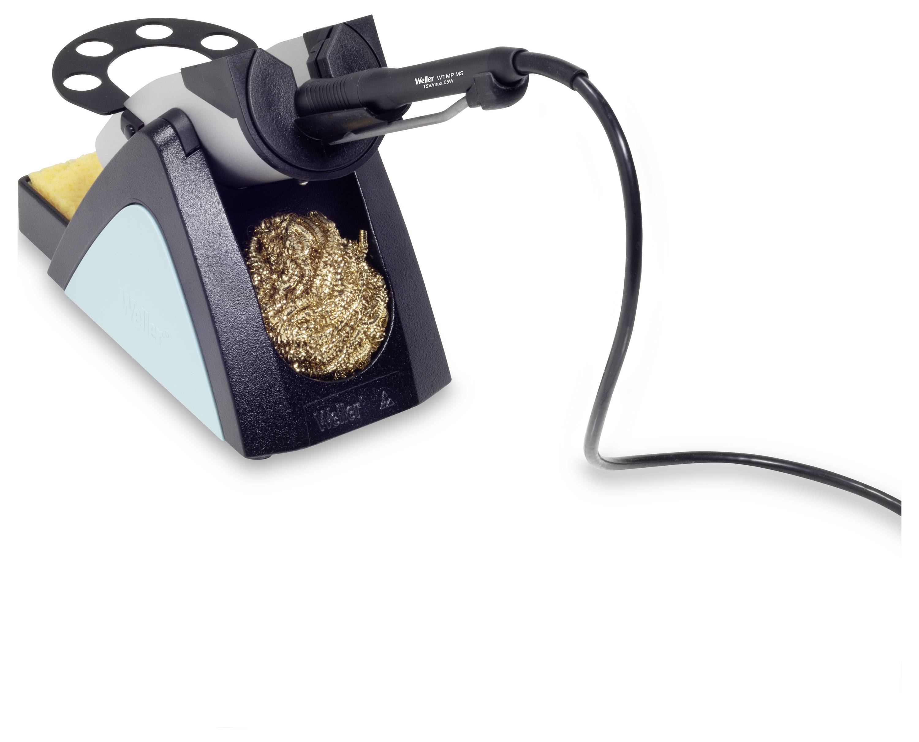 Lutownica stoi pionowo w uchwycie. Obok niej znajdują się gąbka do czyszczenia oraz wełna stalowa.