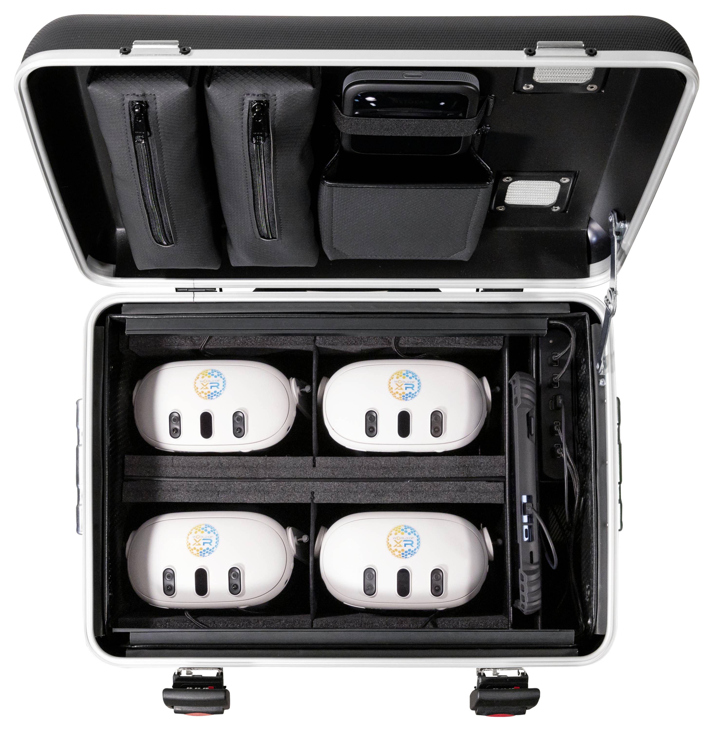 Czarny kufer zawiera sześć białych urządzeń ułożonych w wyściełanych przegródkach, z torbami w pokrywie przeznaczonymi na akcesoria.