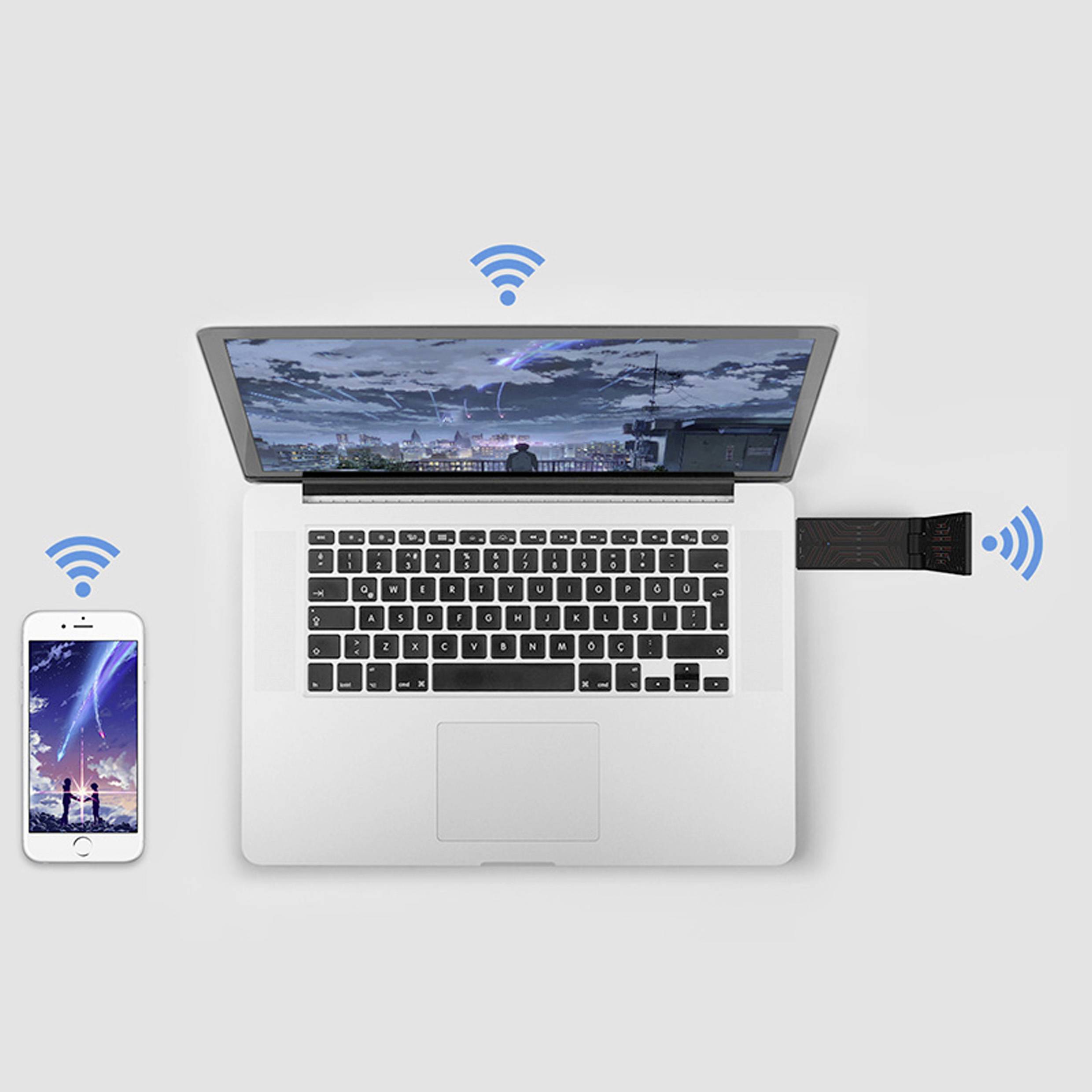 Laptop wyświetla panoramę miasta nocą. Z laptopa wychodzą sygnały Wi-Fi do smartfonu po lewej stronie i urządzenia USB po prawej stronie.