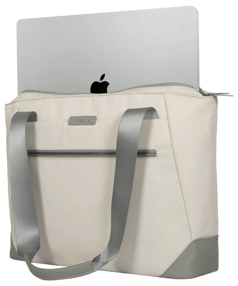 Beżowa torebka z szarymi uchwytami i zamkiem błyskawicznym, z której na wierzchu wystaje laptop.