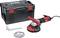 Szlifierka z czerwonym uchwytem przed czarną skrzynką narzędziową, obok klucz i tarcza szlifierska.