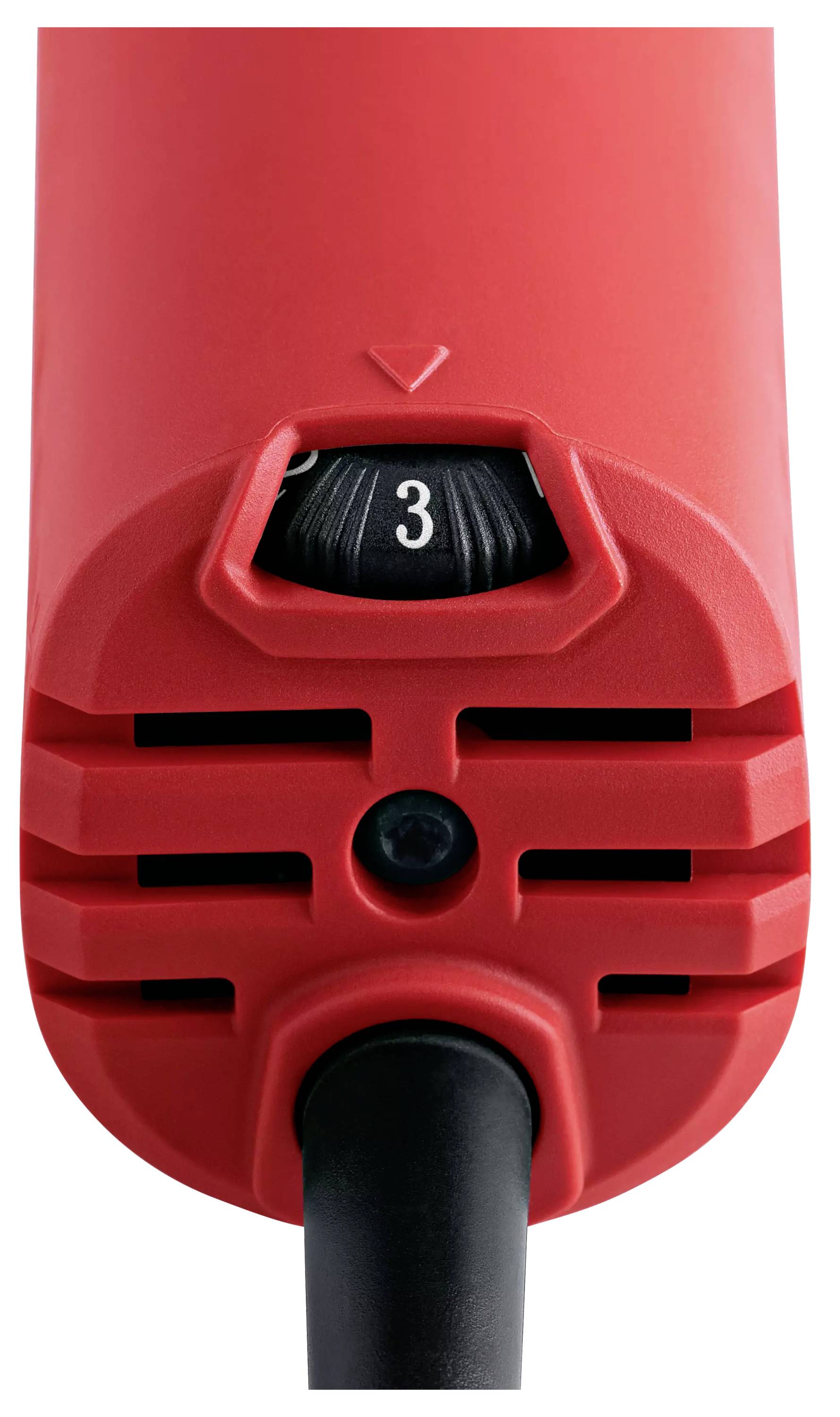 Czerwone urządzenie elektryczne z czarnym pokrętłem ustawionym na '3'. Urządzenie posiada szczeliny wentylacyjne i czarny przewód.