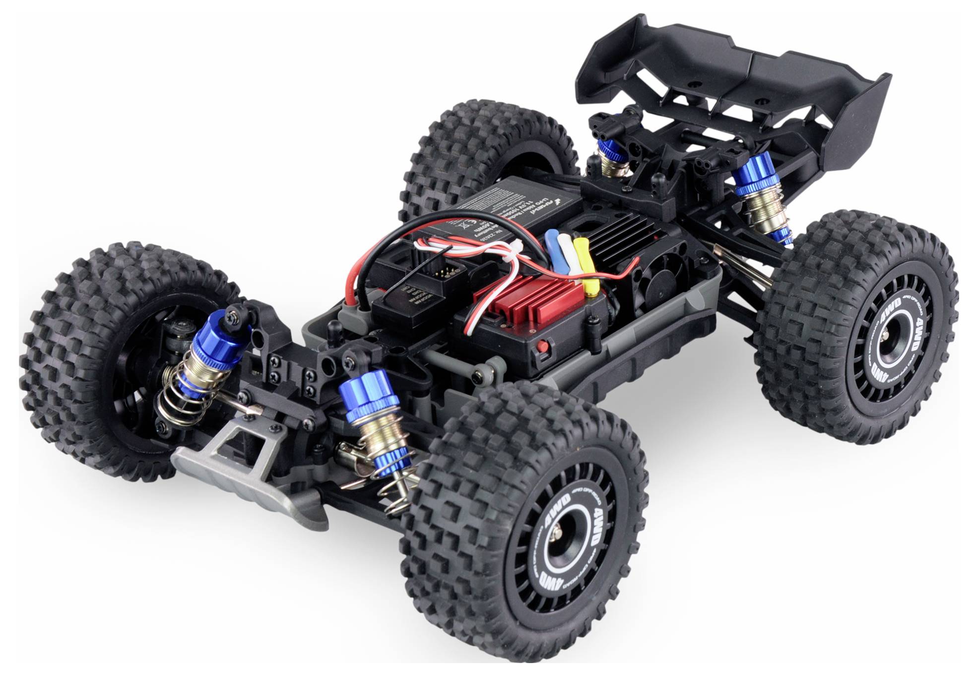 Zdalnie sterowany samochód bez nadwozia, ukazujący szczegóły zawieszenia, elektroniki i podzespołów napędowych. Grube opony do jazdy w terenie.