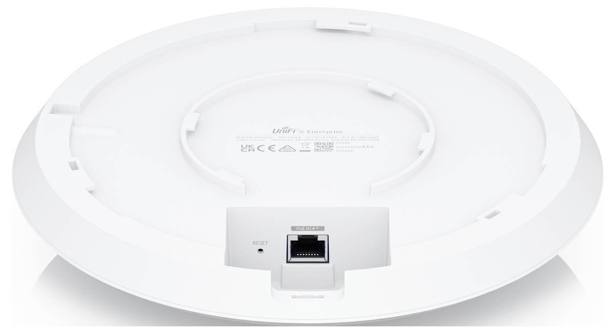 Spód okrągłego urządzenia z gniazdem Ethernet i przyciskiem resetowania.