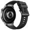 Smartwatch z czarnym paskiem, obudową metalową i okrągłym czujnikiem na tylnej stronie, prezentowana od spodu.
