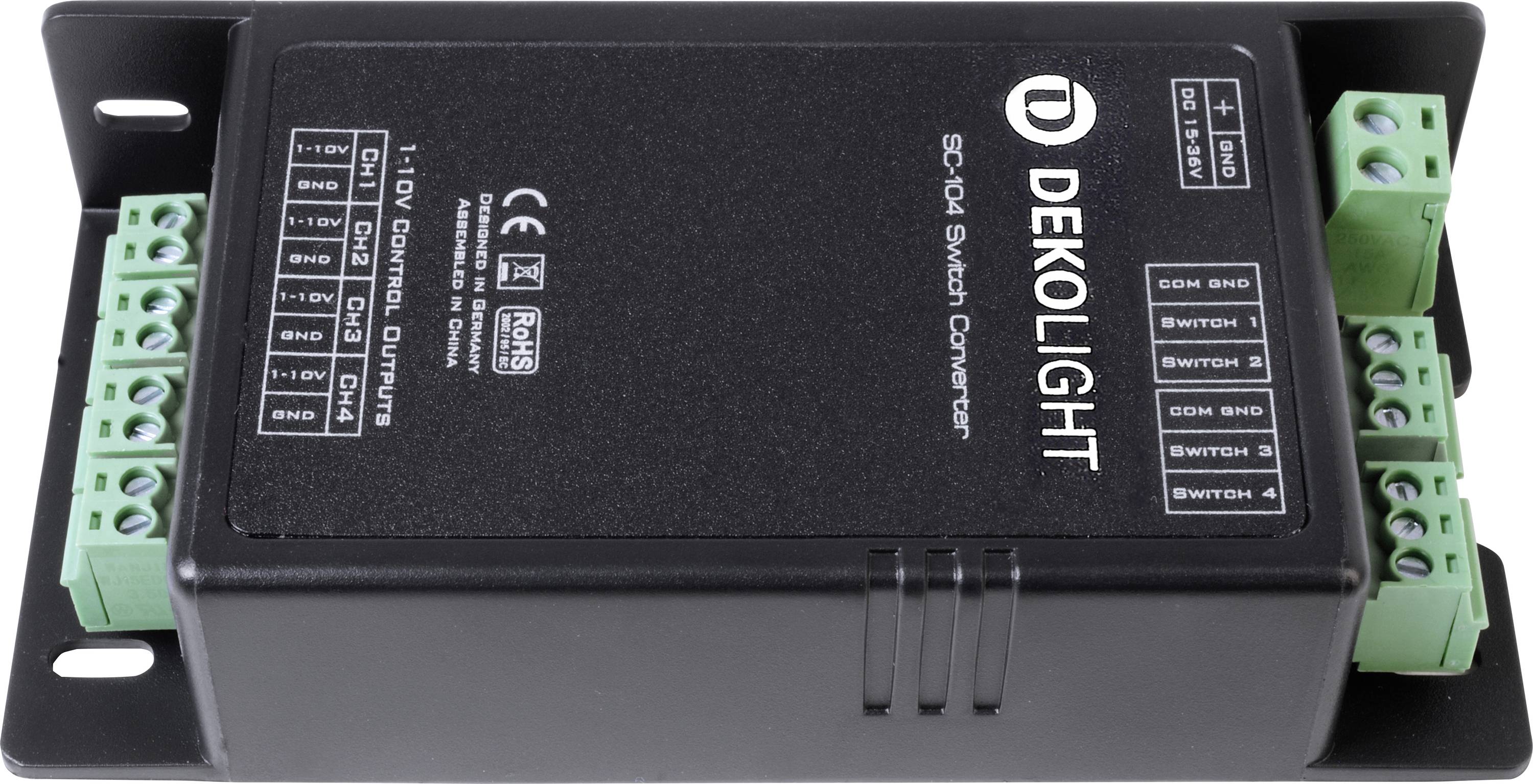 Czarny konwerter DEKOLIGHT SC-10I Switch z zielonymi zaciskami przyłączeniowymi po bokach, przeznaczony do sterowania systemami oświetleniowymi.